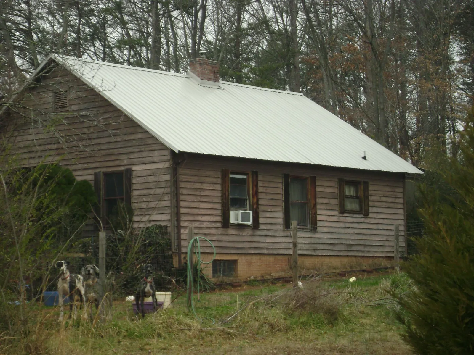 White metal roof on an old wood sided farmhouse, from a Metal Roof Installation job in Loretto